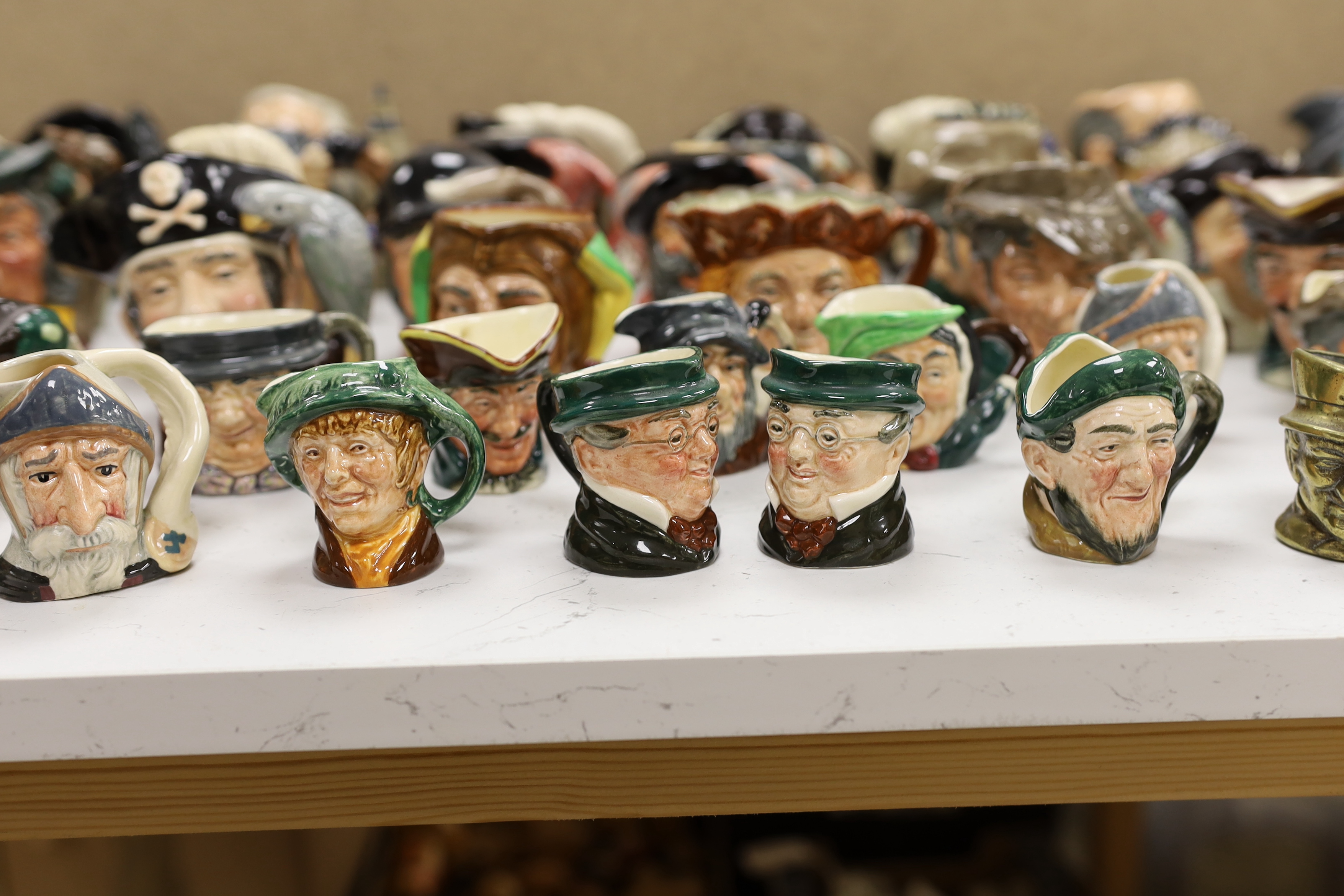 A large collection of Doulton character jugs including the Three Musketeers and Bacchus, largest 10cm high